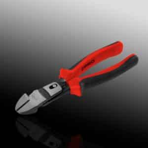 Red and black handled wire cutters on reflective surface.