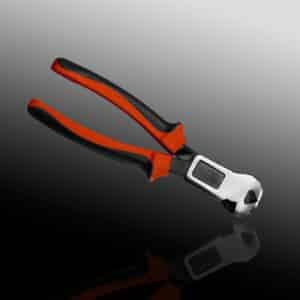 Red-handled wire cutter pliers on reflective surface.
